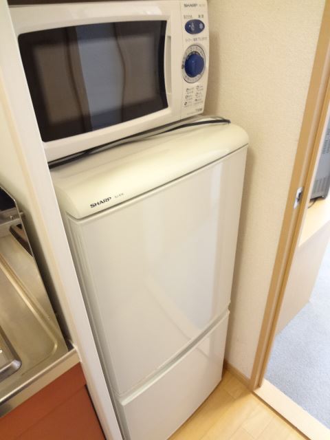 Kitchen. Refrigerator and microwave. Product will vary depending on your room. 