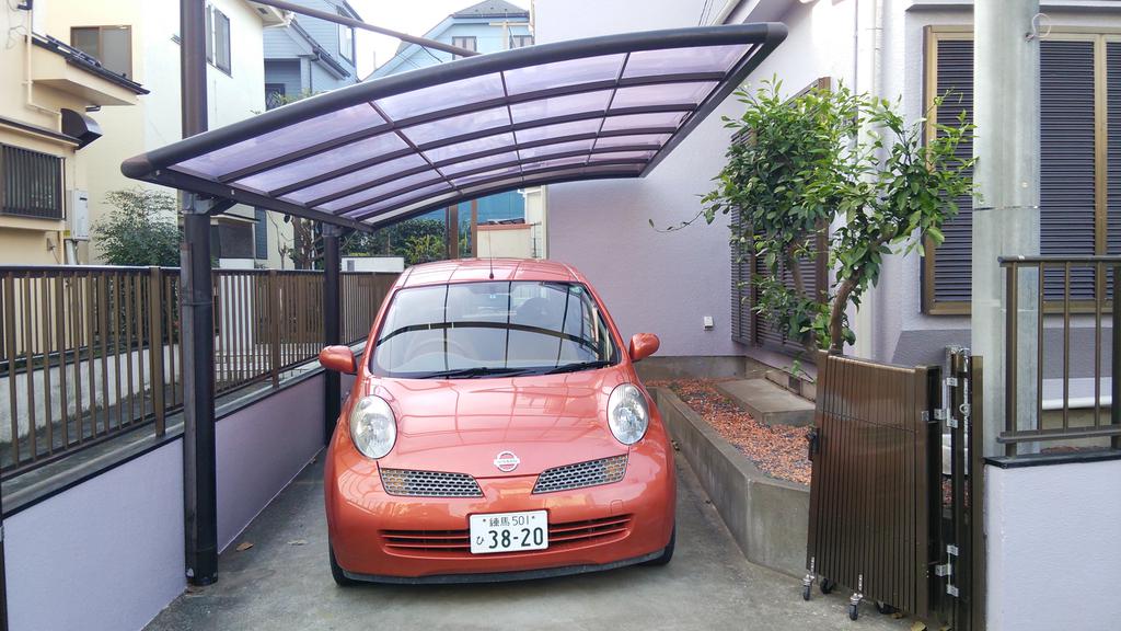 Parking lot. It is a carport with a roof. 