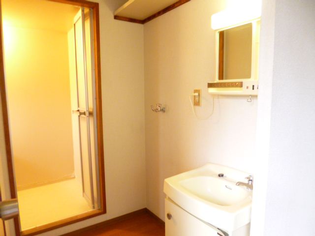 Washroom. Sink and washing machine inside the room