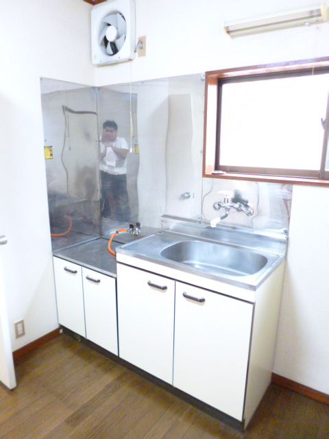 Kitchen. Pat is also cooking because the two-burner stove is put.