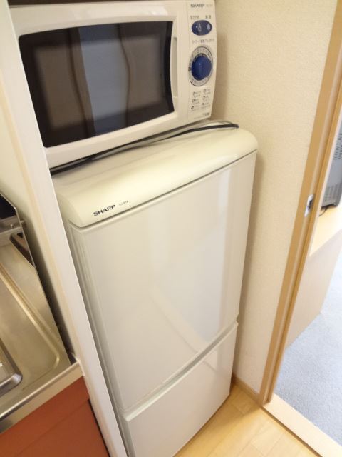 Kitchen. Refrigerator and microwave. Product will vary depending on your room.