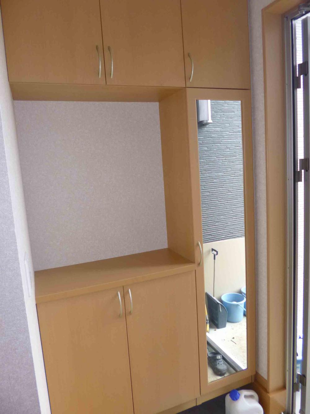 Entrance. Example of construction. Shoes closet with mirror. 