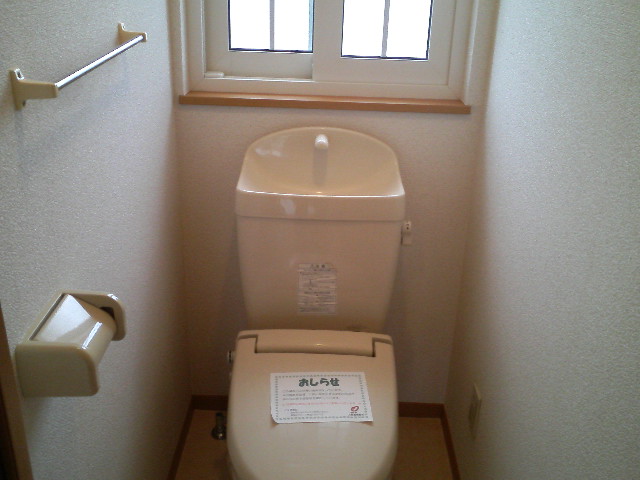 Toilet. It is a window with bright toilet