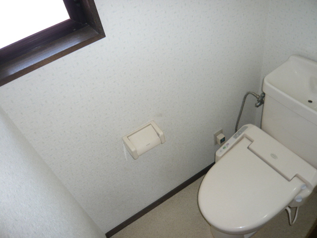 Toilet. It is a photograph of another room in the same building. 