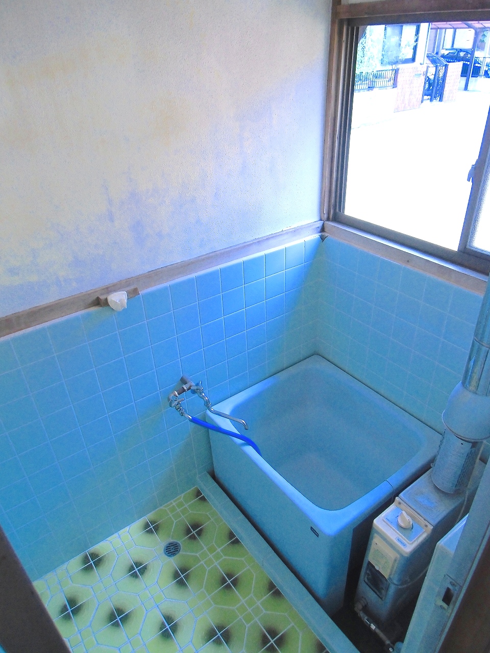 Bath. It is a bathroom with a small window