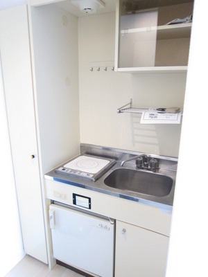 Kitchen. It is with a shelf that small items can be stored there is also a mini-fridge