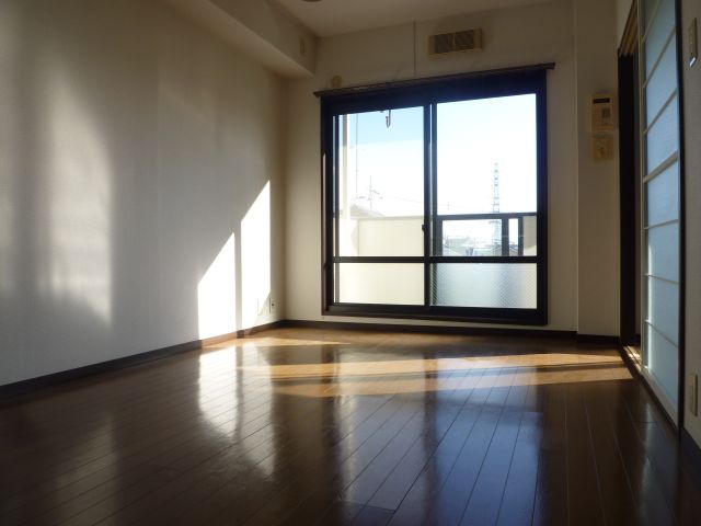 Living and room. It is a bright room with wooden floors.