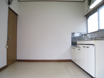 Living and room. There is a window, Bright kitchen