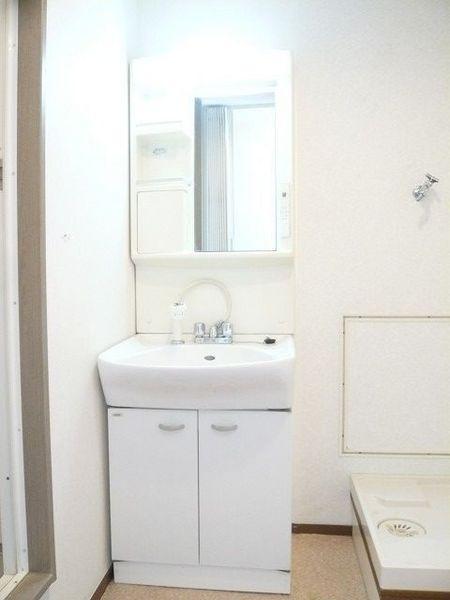 Wash basin, toilet. White shampoo dresser.