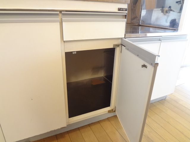 Other. It is housed under the kitchen.