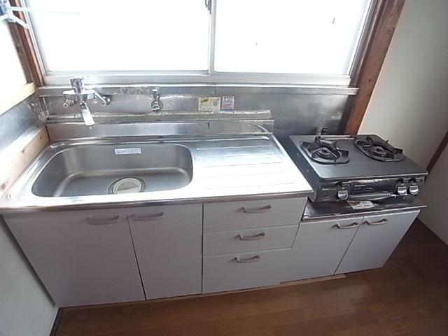 Kitchen. There is also a gas stove. With window