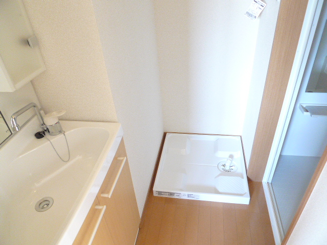 Washroom. Sink and washing machine inside the room