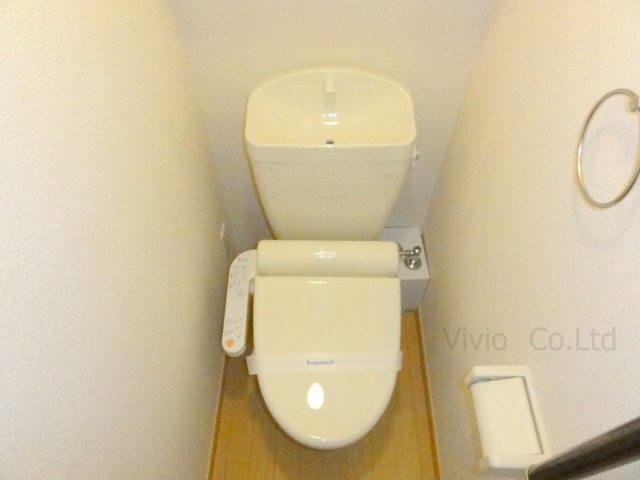 Toilet. It is with warm water washing toilet seat.