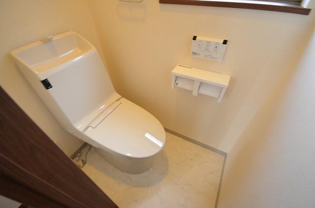 Toilet. First floor toilet is compact design and thin tank. It is with warm water washing toilet seat. Easy-to-use remote control wall. (4 Building)
