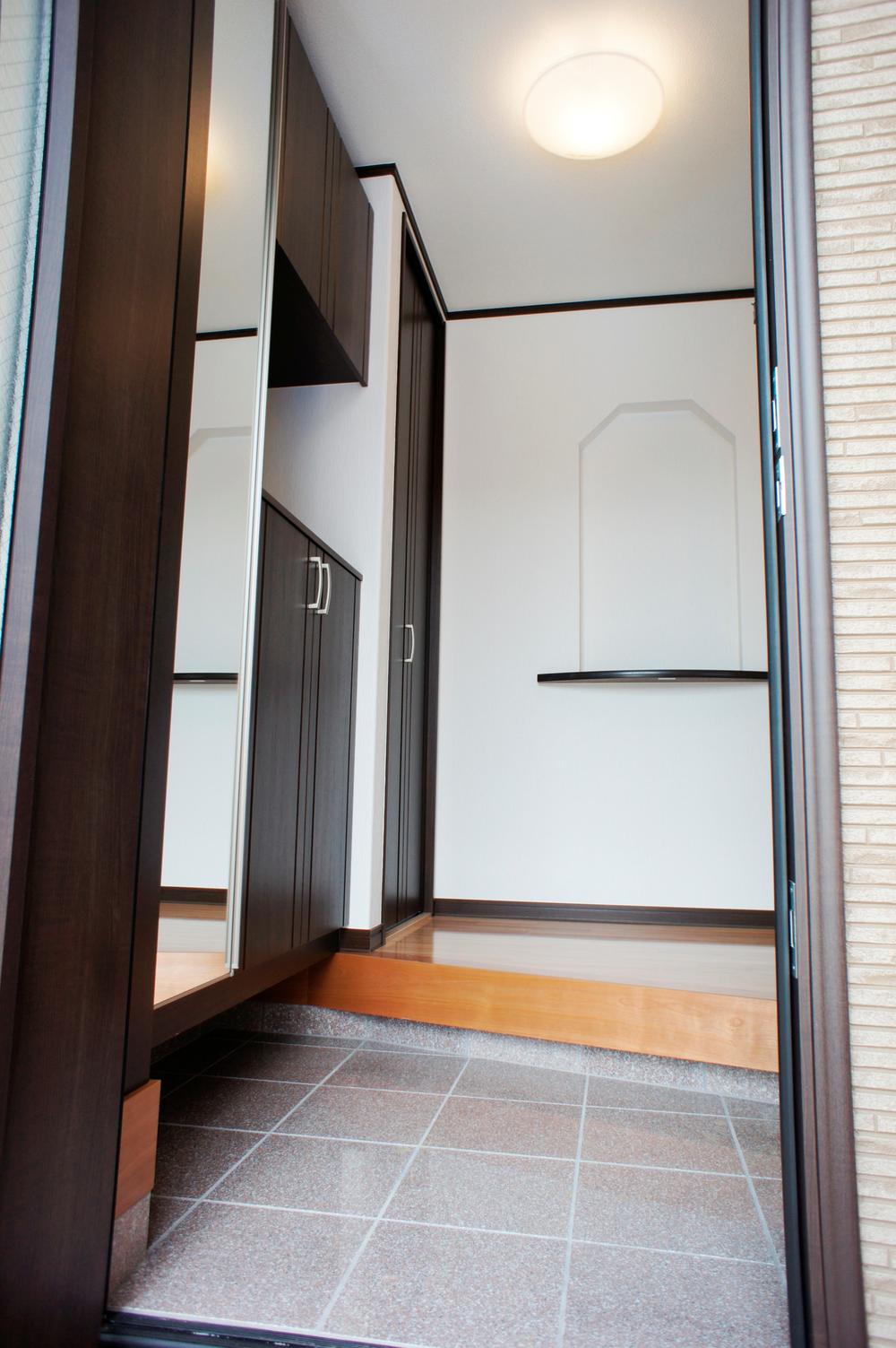 Entrance. Marked with cupboard a large full-length mirror is storage capacity also plenty