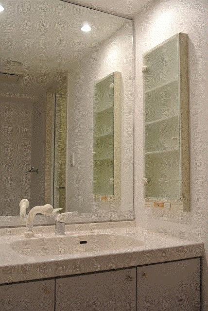 Wash basin, toilet. Vanity easy to see in the large mirror