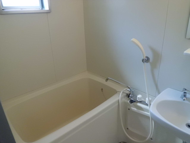 Bath. Bathroom with a window. It is with wash bowl