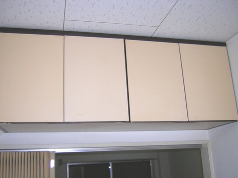 Living and room. There shelf hanging in the kitchen top. Convenient food storage equipment