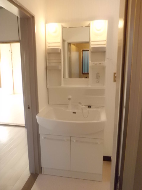 Washroom. New independent wash basin. There is a washing machine storage is next to.