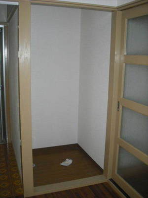 Washroom. Washing machine in the room