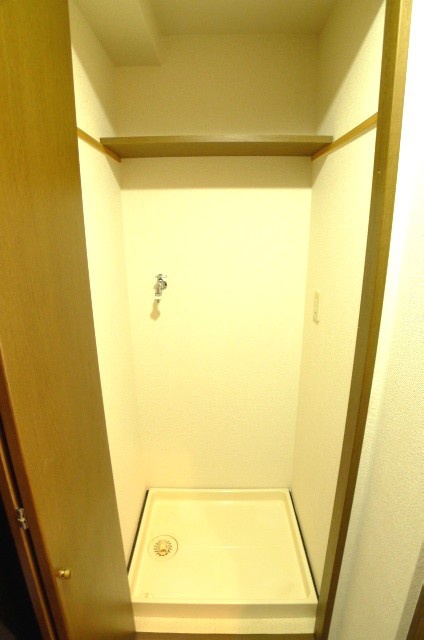 Washroom. Washing machine in the room