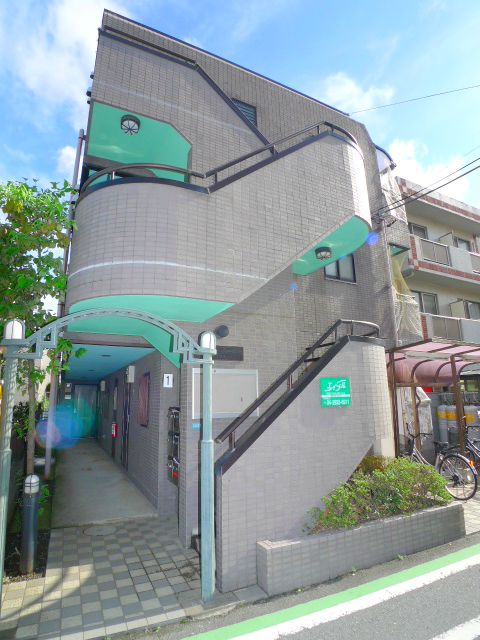 Building appearance. There yard bicycle.