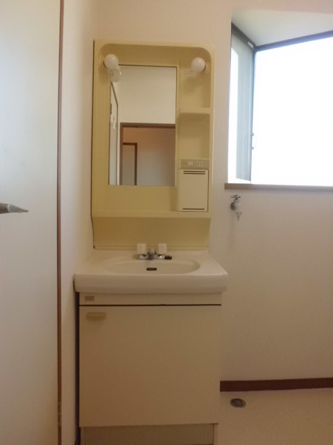 Washroom. Independent sink and washing machine inside the yard.