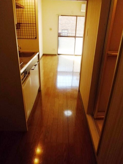 Living and room. There is a kitchen space in the hallway