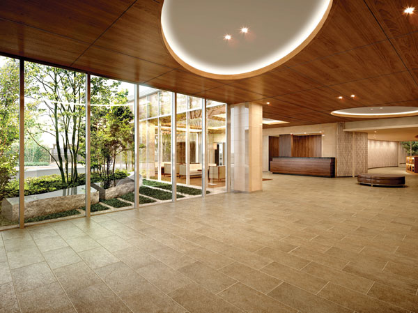 Features of the building.  [Entrance hall] Comfortable design space ceiling and natural stone woodgrain produces. It reflects the rich shadows lighting the carefree space, Planting visible from the windows, Gently insist on aesthetics appropriate to nature of the earth. Because it is where the beauty and richness is in harmony and hospitality of the people that space is coming of what born welcome. (Rendering)