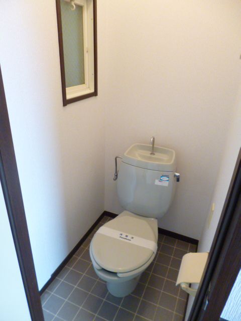 Toilet. It has a window in the toilet. 