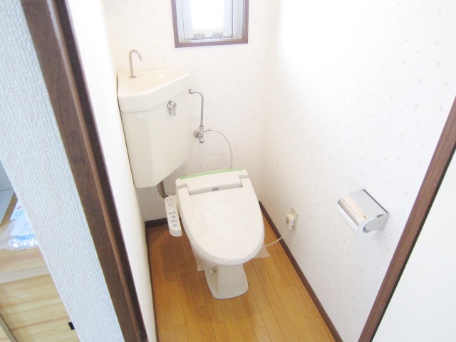 Toilet. Warm water washing toilet seat was also established
