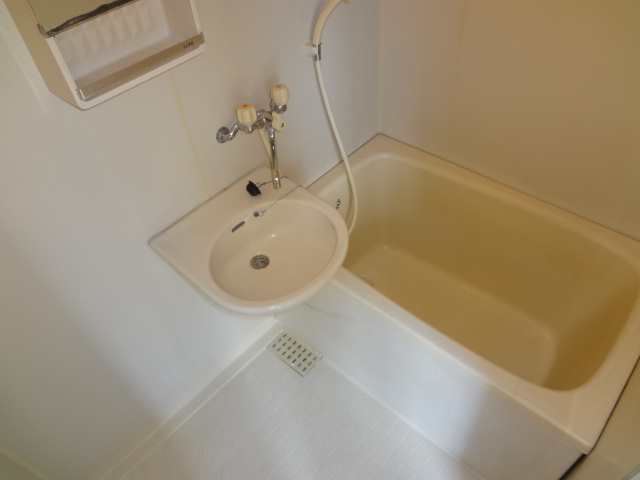 Bath. Mirror & is a basin with a bathroom