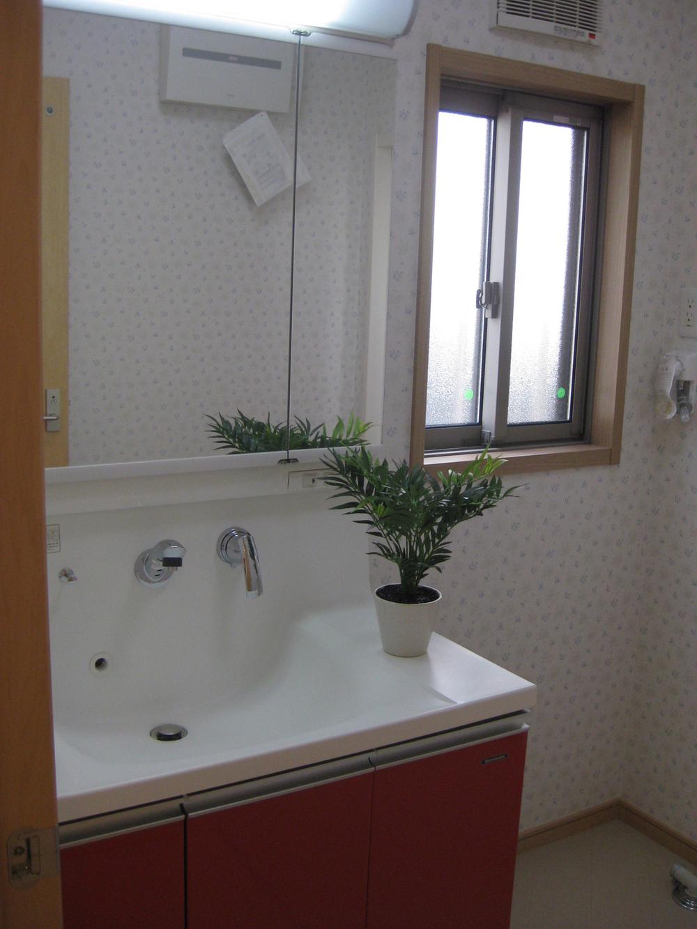 Wash basin, toilet. Washroom is full of clean atmosphere. 