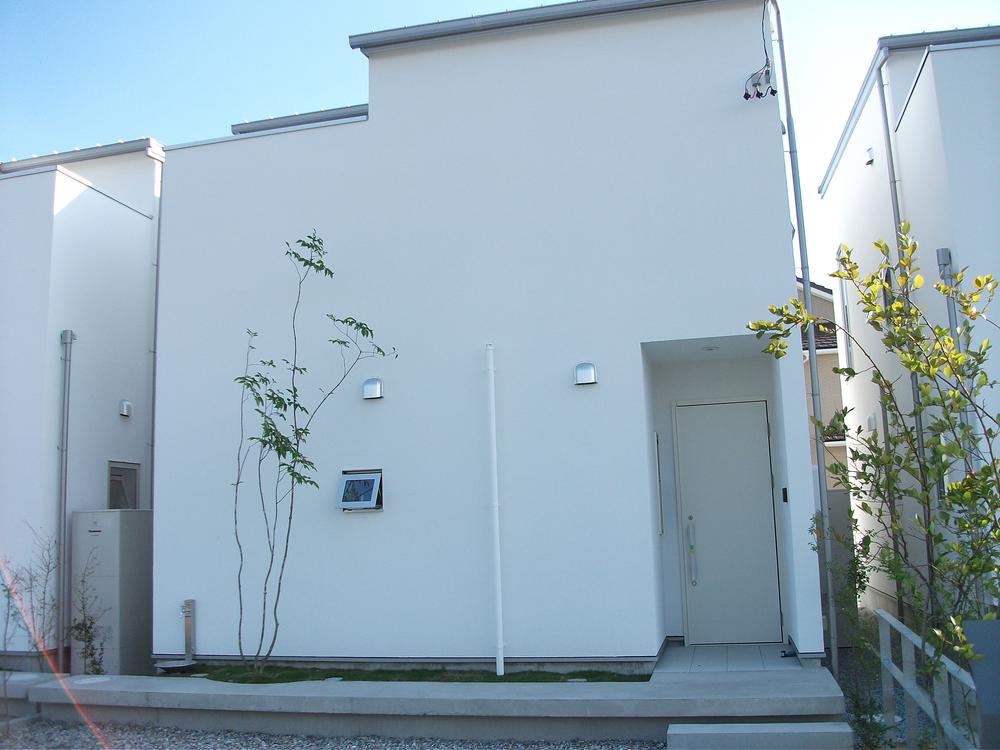 Local appearance photo. Building C. Green accents to simple appearance. 