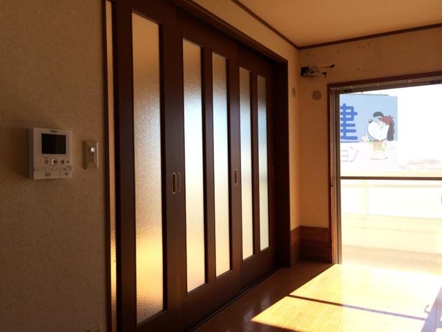 Living. Guests bright room with frosted glass of the sliding door.