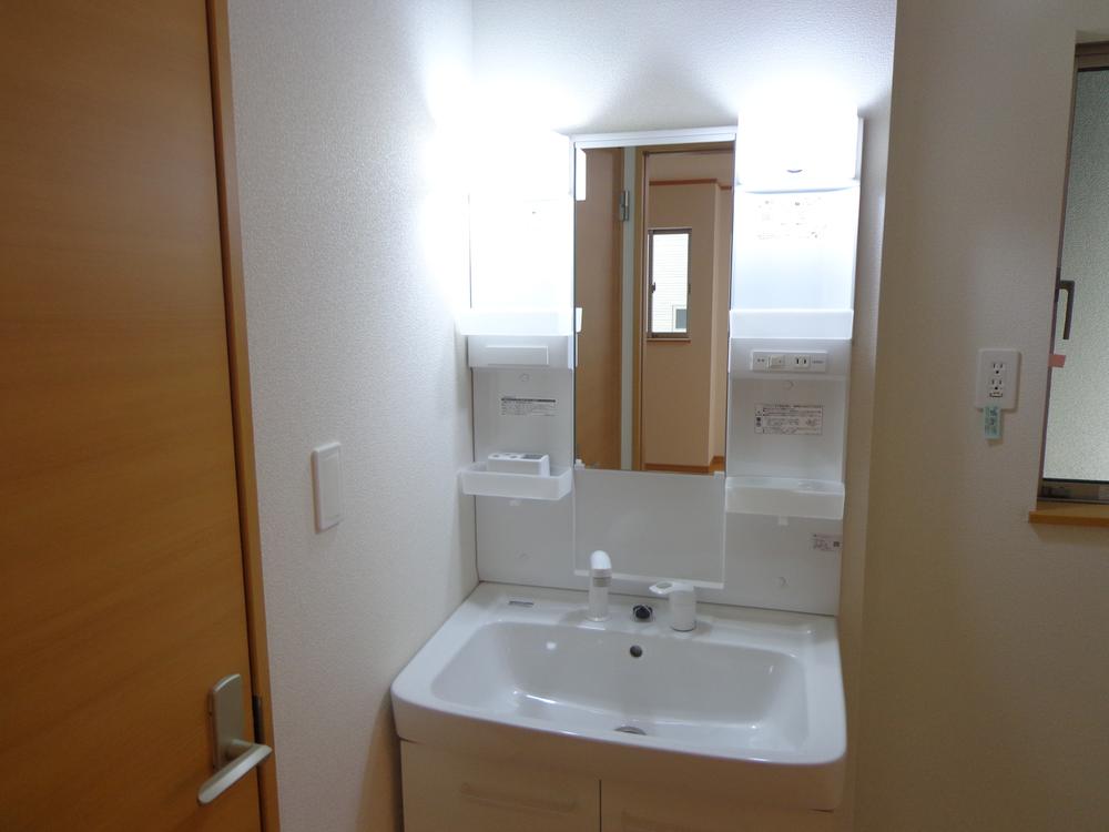 Wash basin, toilet. Vanity with a shower head