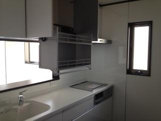 Kitchen. Unified kitchen with fresh white. Hanging cupboard of storage capacity. Stove, Easy to clean flat. 