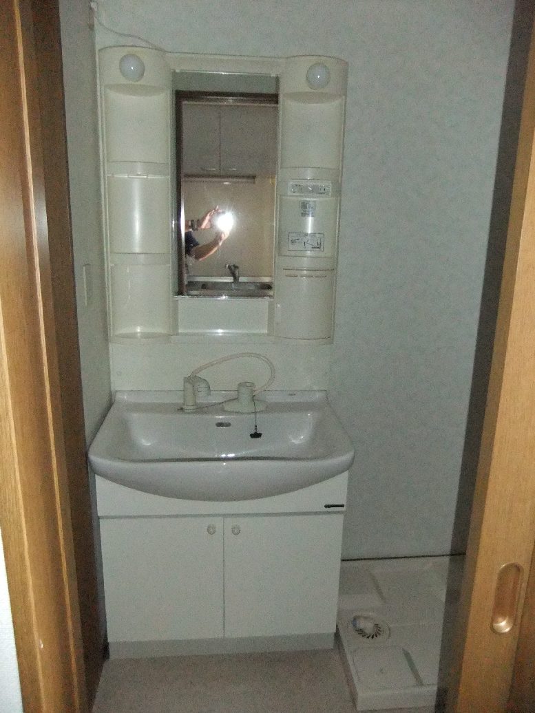 Washroom. Vanity unit is the type that has the shower head.