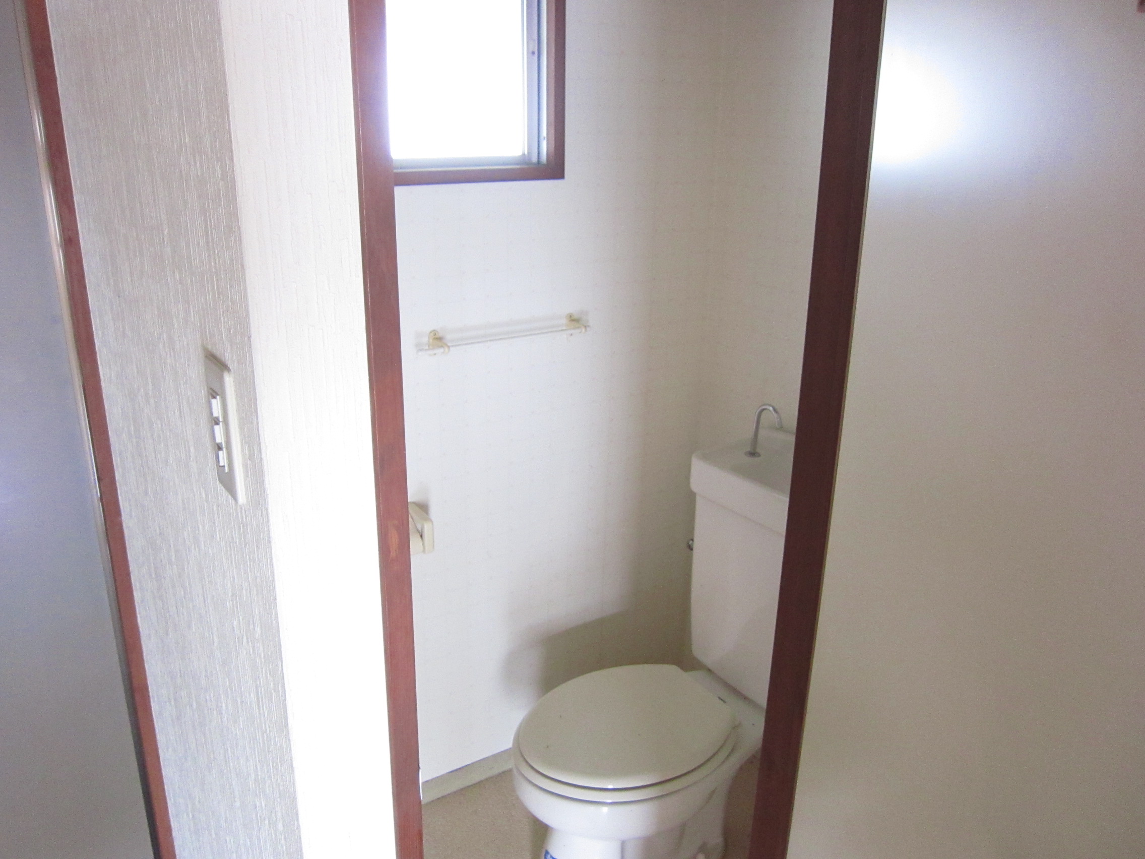 Toilet. It is bright because there is a window!