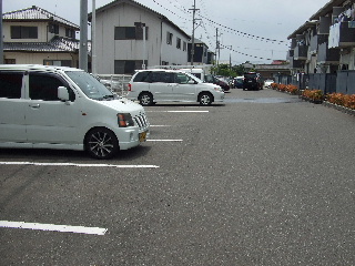 Parking lot. It is safe in a wide parking space.