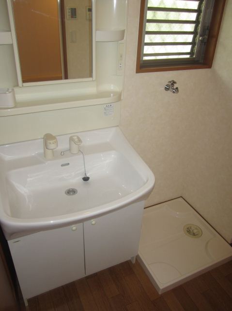 Washroom. Large washbasin and happy indoor washing machine Storage