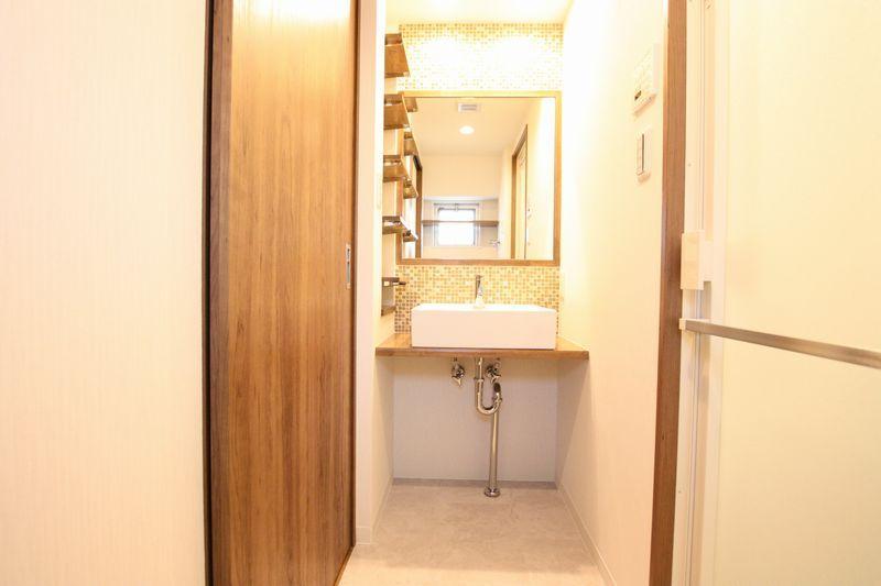 Wash basin, toilet. Wash basin was finished with mosaic tile specification