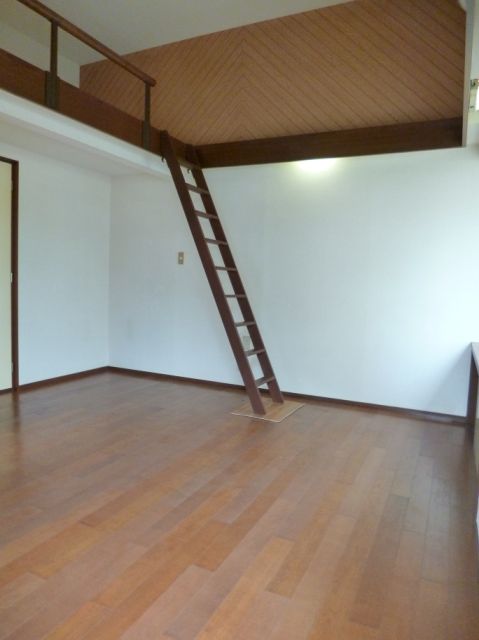 Living and room. It is a loft with a room.