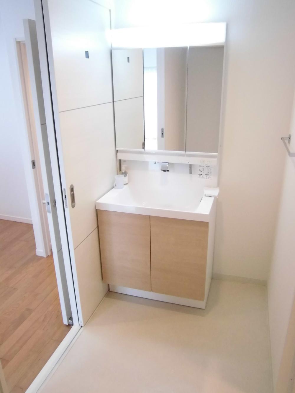 Wash basin, toilet. It is the washroom