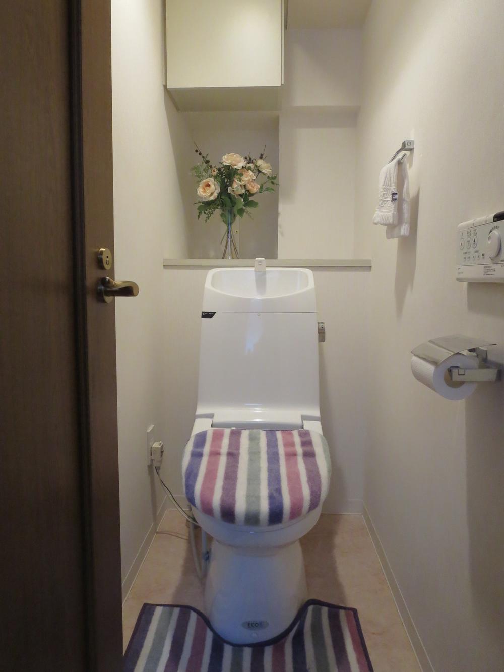 Toilet. Toilet is also a pre-renovation! It is also equipped with shelves
