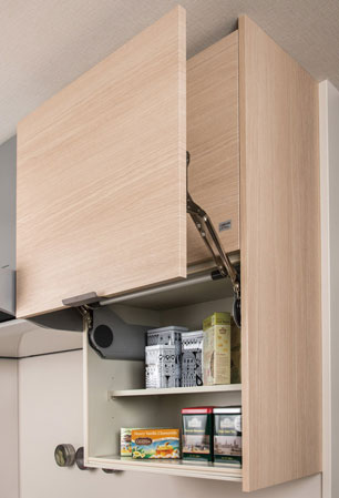 Kitchen.  [System Wall storage] And to half the width of the hard-to-reach heights of hanging cupboard, Extend the opening of the kitchen. Even during the cooking, The bottom of the hanging cupboard is put in the left open.  ※ Equipment photo model Room E type