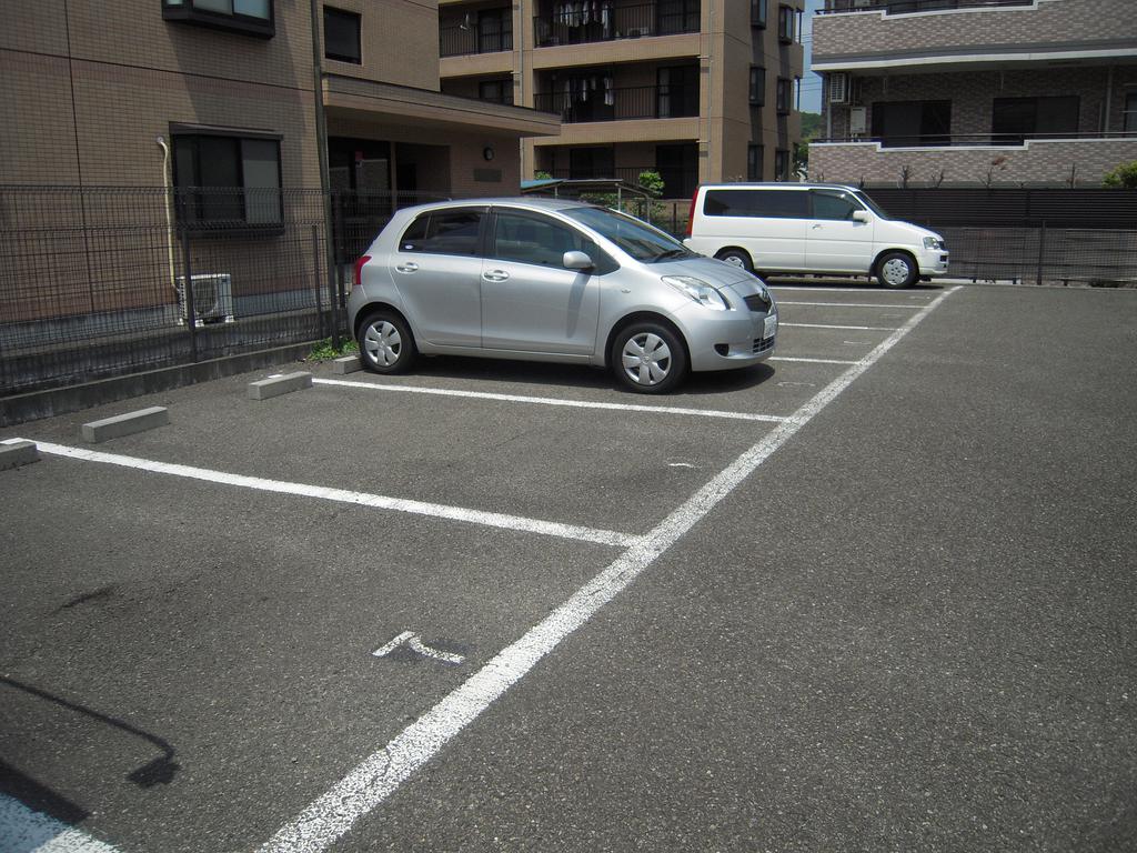 Parking lot. It is the entire surface of the pavement.