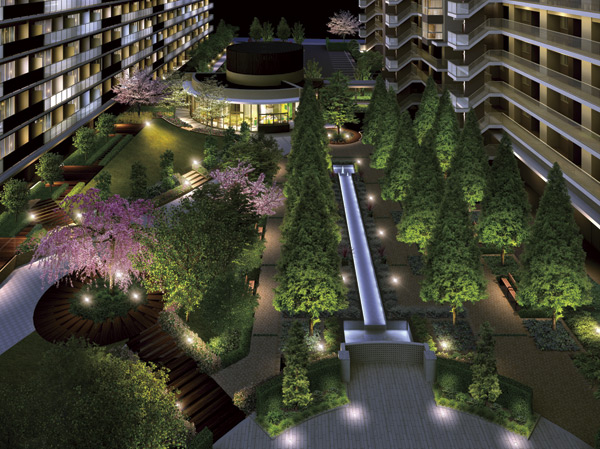 Features of the building.  [Lighting plans to draw a landscape] You warmth lighting if at night in light gently color of the four seasons of "Four Seasons Garden". Light up Ya to draw a circle, A band of light Features specific to illuminate the tree-lined, Fantastic landscape filled with peace is, Welcomes the people you live. (Rendering CG)
