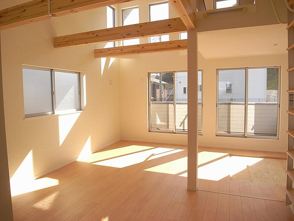 Living. Bright living room with a slope ceiling and loft