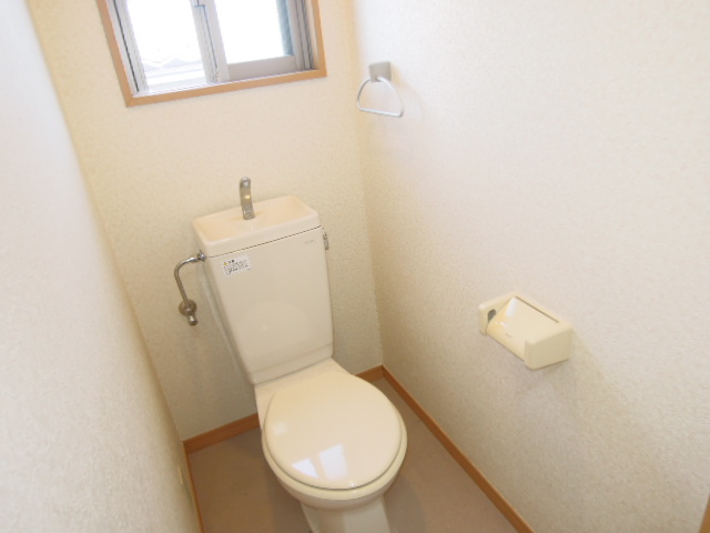 Toilet. Small window with toilet